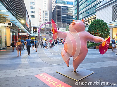 Cute pink pig sculpture with funny posture to celebrate year of the pig at World square building. Editorial Stock Photo